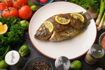 Grilled fish with fresh vegetables, on a wooden black background. I also eat healthy food. Seafood