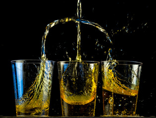 Threesome of whiskey shots exchanging fluids