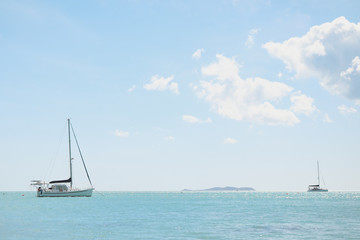 Seaside view with mountains in the distance, bright blue tropical waters of North Queensland off Cape Gloucester