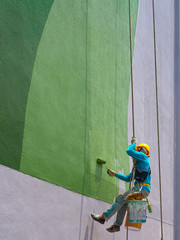 Painters painting exterior of building