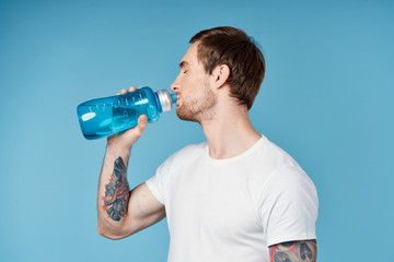 young man drinking water from a bottle