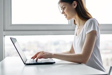 young woman working on laptop at home