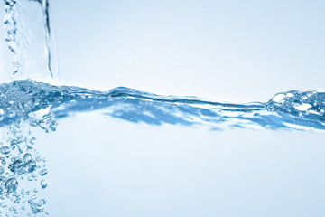 Water splash. Aqua flowing in waves and creating bubbles. Drops on the water surface feel fresh and...