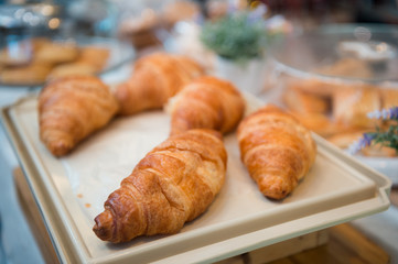 Croissant placed on a white tray