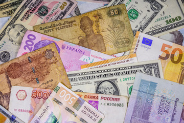 Multi currency background. Euro, american dollars, ukrainian hryvnias, egyptian pounds, russian roubles