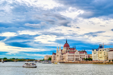 Naklejka premium The Hungarian Parliament Building located on the Danube River in Budapest Hungary at sunset.