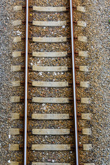 Top view of the railroad tracks on gravel