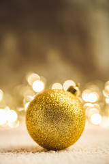 Christmas ball on snow flakes. Selective focus. Shallow depth of field.
