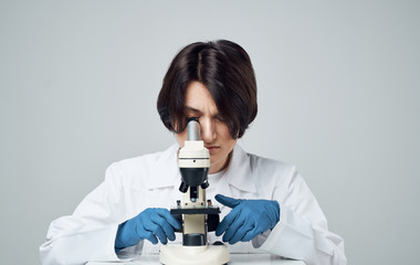 scientist looking through microscope