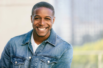 Close up head shot of a handsome commercial african american model with perfect white teeth smile...