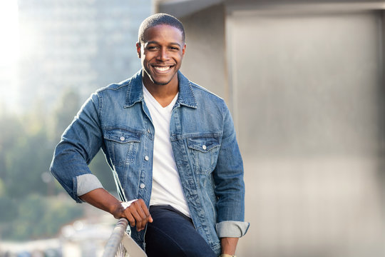 Casual lifestyle portrait of an african american male with perfect white teeth smile, commercial model