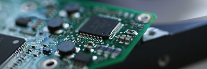 Electronic board with microchips on a hard drive background