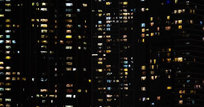 Time lapse of apartment building at night. Turns on and off the light in the windows. 4K.