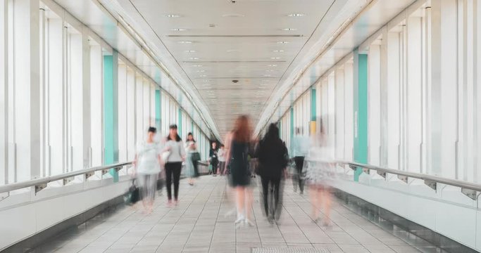 Time lapse of passenger walking on the footbridge walkway.