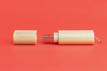 Wooden USB flash drive on red background