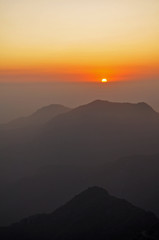 Obraz premium Orange Sunset over Mountain Range