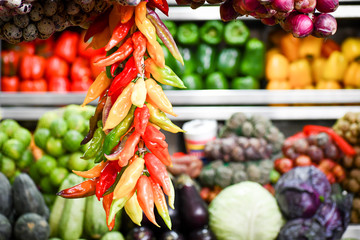 Cluster of colored chili peppers in Peruvian market.