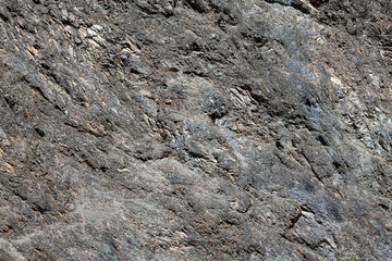 Background with a rough texture of gray and brown color of stone and rock on the mountain. Decor and desigh of interior.