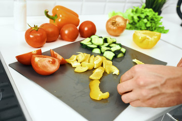 woman cutting vegetables in kitchen