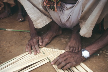 Kokre weaving a soup. A soup is woven item made of bamboo which is mainly used for winnowing grain,...