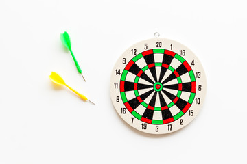 Darts game - simple sport for lesure time. Dartboard and arrows or dart on white background top view