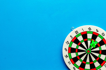 Darts game - simple sport for lesure time. Dartboard and arrows or dart on blue background top view...