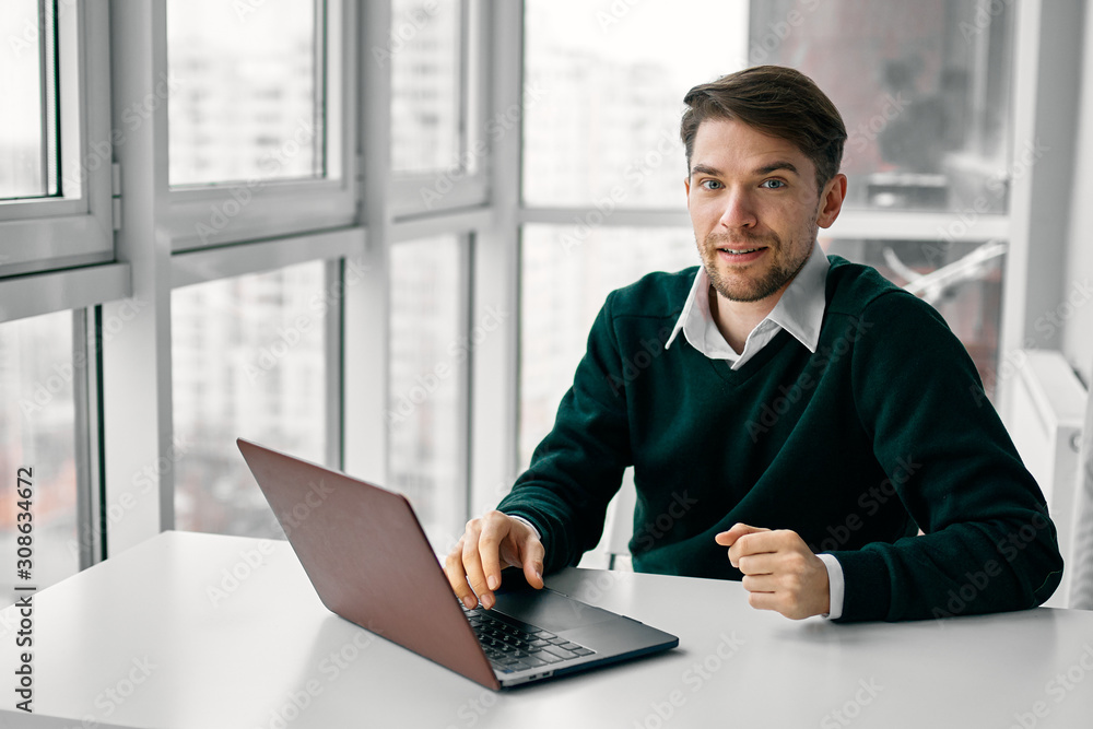 Wall mural businessman working on laptop in office