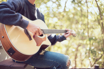 Natural guitarist, People playing acoustic guitar in the garden, Close-up