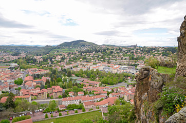 Fototapeta na wymiar The hill view on orange roofs of le Puy-en-Velay city in France