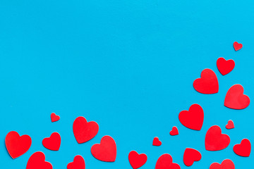 Valentine's Day design. Red hearts frame on blue background top-down copy space