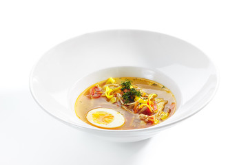 Chicken Soup with Tagliatelle Pasta, Eggs and Fresh Herbs Isolated