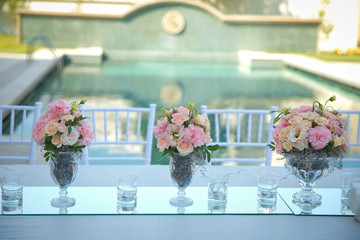 Flowers in a glass cup. flowers on a glass table. Flowers in a glass cup. flowers on a glass table.
