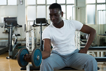 Man doing exercises with dumbell