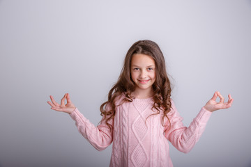  cheerful toothy shining girl meditating doing yoga isolated on a white background