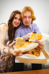 Funny couple eating pizza