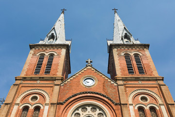 Fototapeta premium Notre Dame Cathedral with blue sky in Ho Chi Minh City, Vietnam
