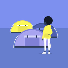 Young black female tourist standing in front of the tents on a campsite, outdoor leisure