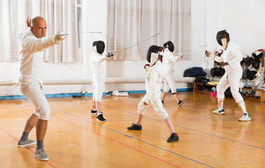 Portrait of sports focused practicing with foil