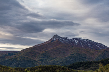 Snowy cloudscape sky with mountain snowy peak in Catalonia mountains landscape