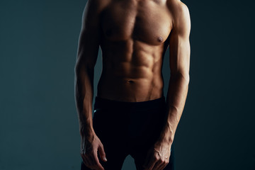Fototapeta na wymiar muscular man posing on black background