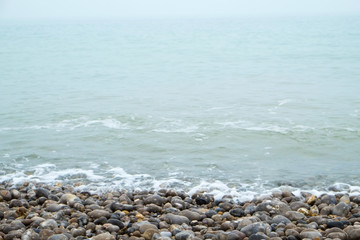 French coastline of Normandy in France with pebbles beaches, part of the typical landscape 