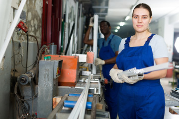 Portrait of woman worker who is occupation near special machine