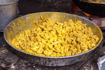 Street food in Amtrisar, India. Cauliflower prepared for frying.