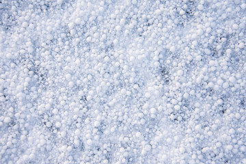 Background texture of snow cover in the form of round grains.