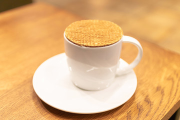 Stroopwafel is a famous Dutch treat. Place the waffle on top of tea or coffee mug. Leave it there for a few minutes until it starts to soften; good smell and melted caramel inside.