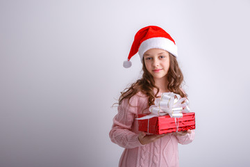 smiling little girl in Santa hold  gift  on isolated white background