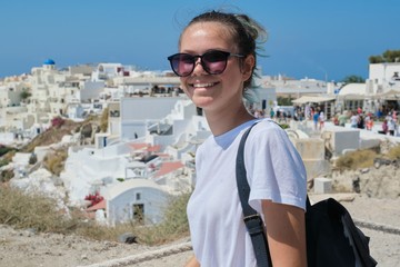 Fototapeta na wymiar Smiling teenager posing on the island Santorini, from Oia, Greece