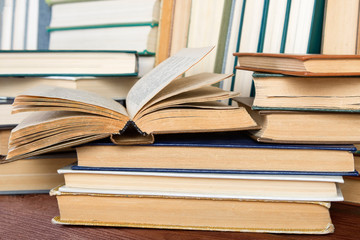 Open book on wood desk in the library room  for education background and back to school concept.