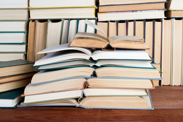 Open book on wood desk in the library room  for education background and back to school concept.