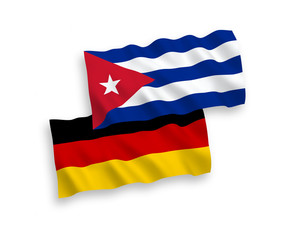 National vector fabric wave flags of Germany and Cuba isolated on white background. 1 to 2 proportion.